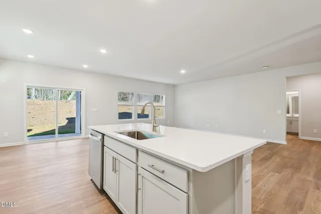 a open kitchen with stainless steel appliances granite countertop a sink and cabinets