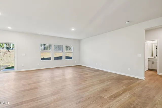 an empty room with wooden floor and closet
