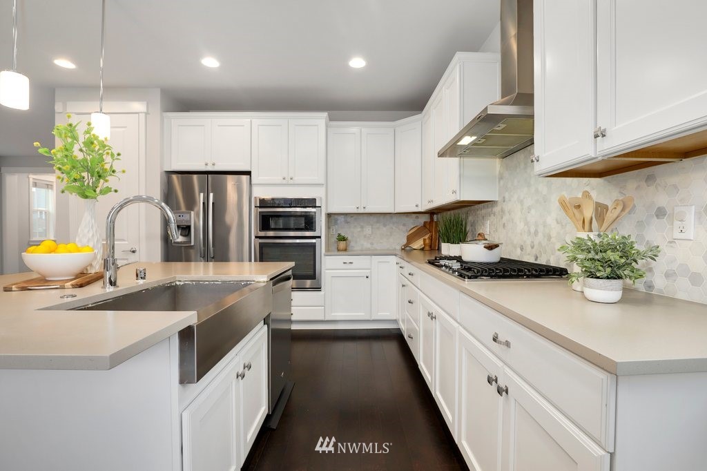 4327 223rd Place Southeast Bothell, WA 98021 - Photo 11 of 40 a kitchen with stainless steel appliances granite countertop a sink a stove and a refrigerator