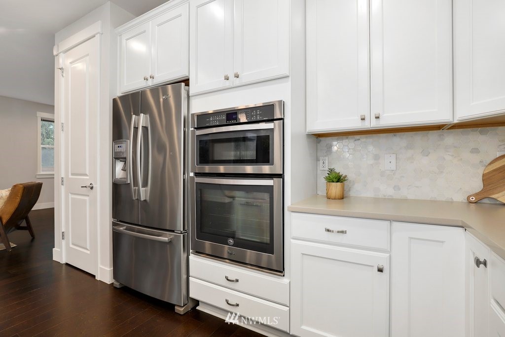 4327 223rd Place Southeast Bothell, WA 98021 - Photo 12 of 40 a kitchen with stainless steel appliances white cabinets and a refrigerator
