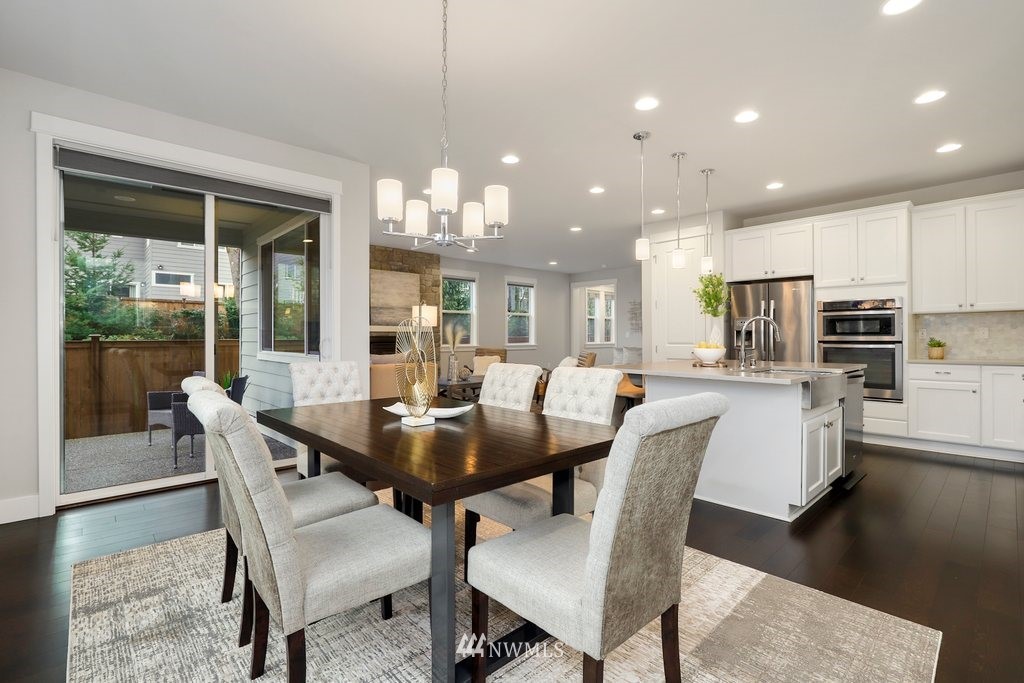 4327 223rd Place Southeast Bothell, WA 98021 - Photo 15 of 40 a dining room with stainless steel appliances kitchen island granite countertop a dining table chairs and view of kitchen