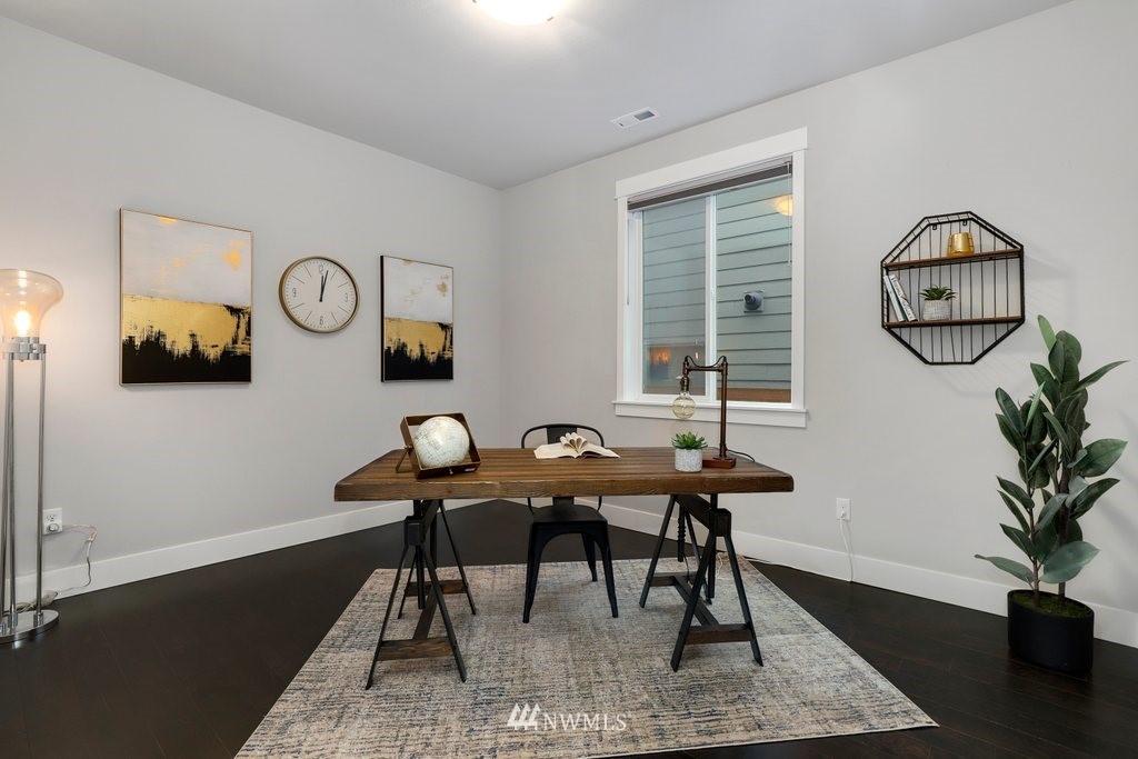 4327 223rd Place Southeast Bothell, WA 98021 - Photo 16 of 40 a view of a work space with furniture and wooden floor