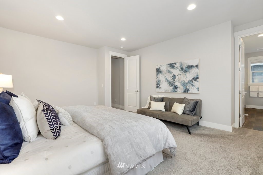 4327 223rd Place Southeast Bothell, WA 98021 - Photo 22 of 40 a bedroom with a large bed and a couch