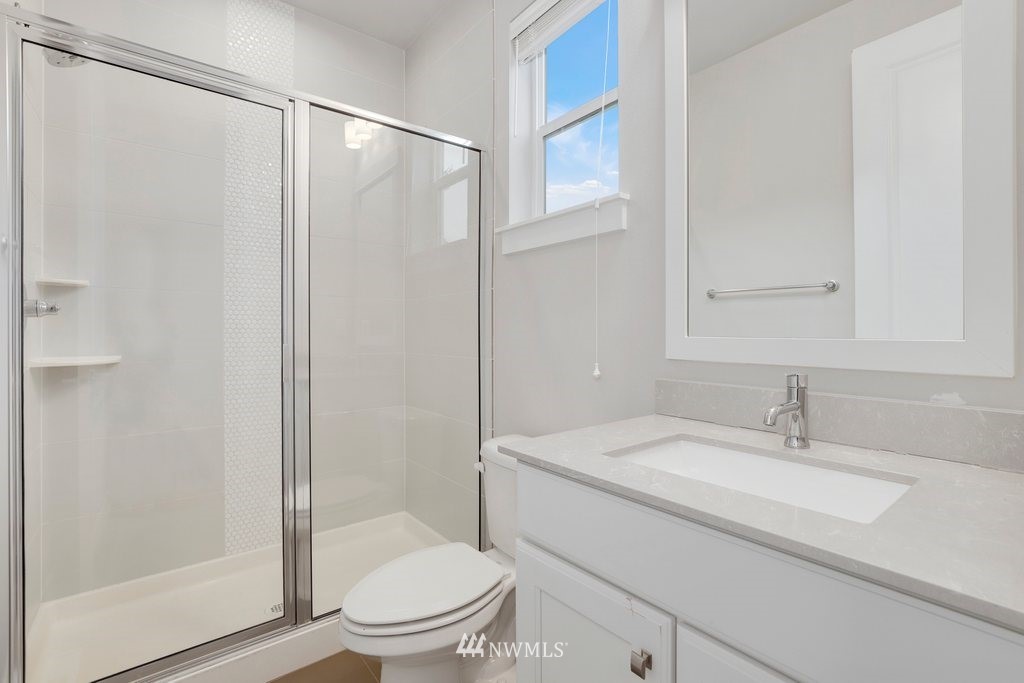 4327 223rd Place Southeast Bothell, WA 98021 - Photo 28 of 40 a bathroom with a granite countertop sink toilet and shower