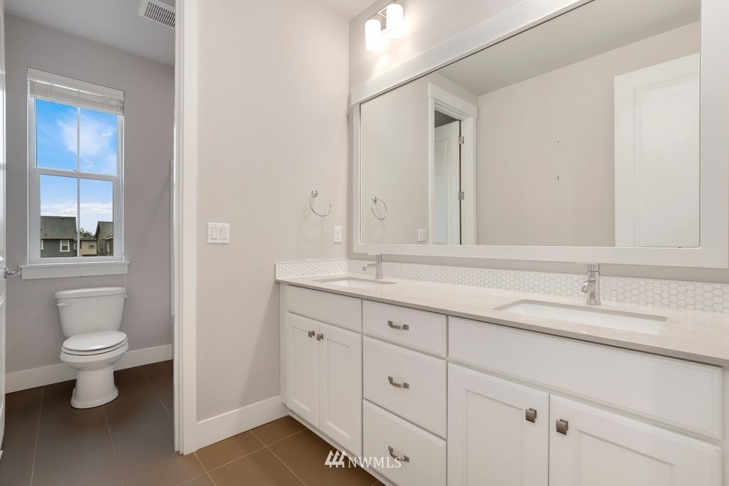 4327 223rd Place Southeast Bothell, WA 98021 - Photo 31 of 40 a bathroom with a sink a toilet and a mirror
