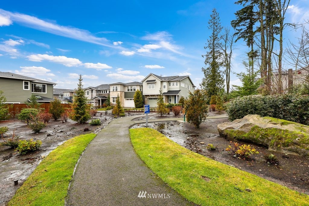 4327 223rd Place Southeast Bothell, WA 98021 - Photo 39 of 40 a view of a swimming pool with lawn chairs under an umbrella