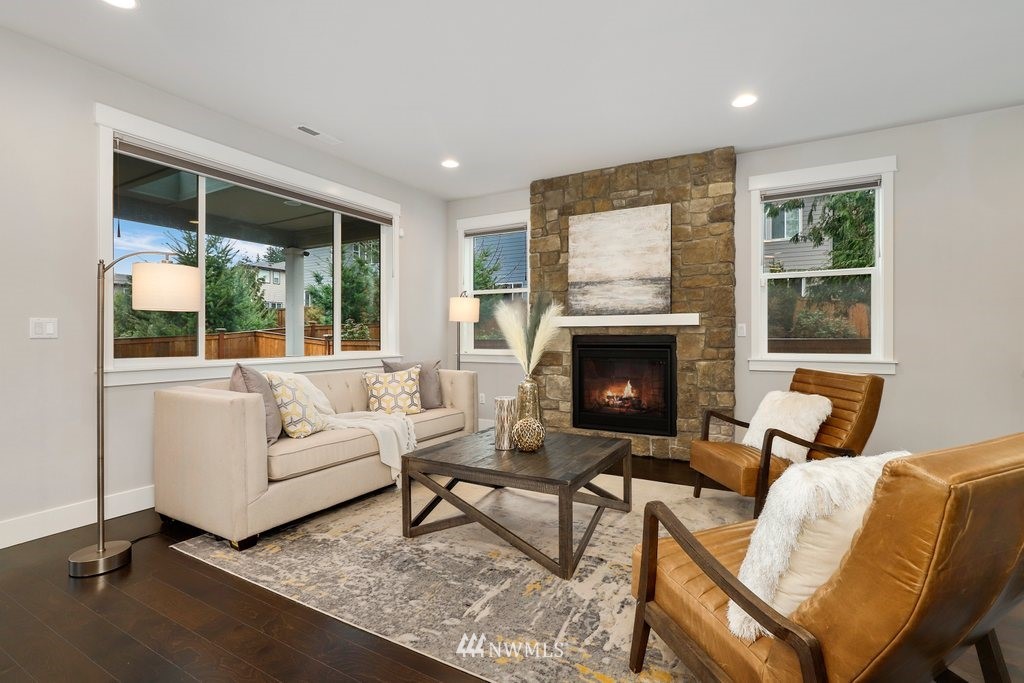 4327 223rd Place Southeast Bothell, WA 98021 - Photo 6 of 40 a living room with furniture and a fireplace