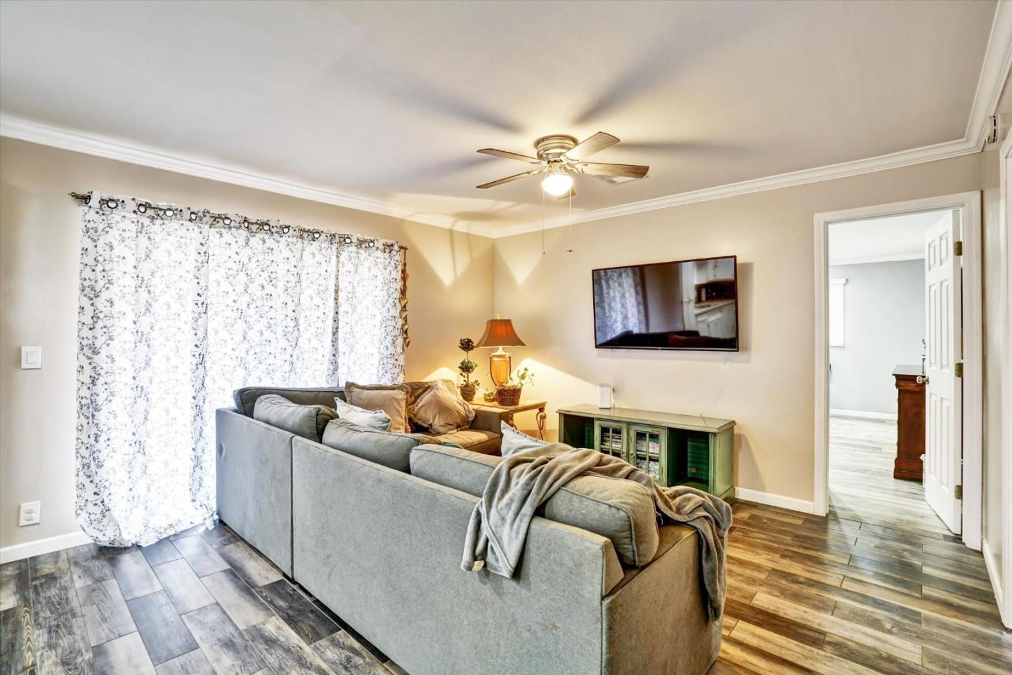 15820 South Harlan Road, Unit 22 Lathrop, CA 95330 - Photo 12 of 18 a living room with furniture fireplace and a flat screen tv