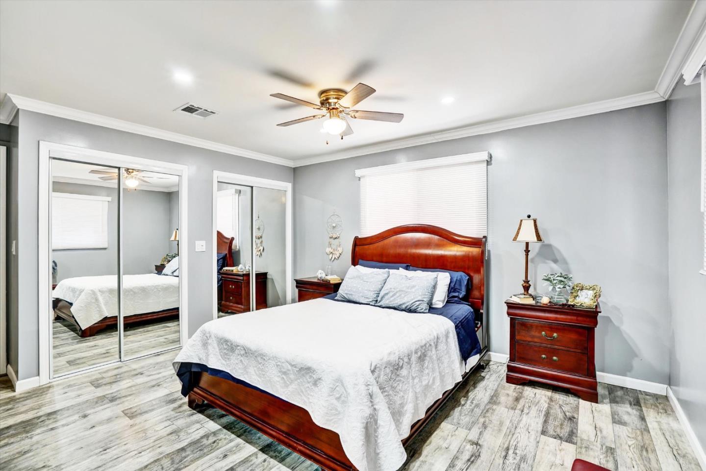 15820 South Harlan Road, Unit 22 Lathrop, CA 95330 - Photo 17 of 18 a bedroom with a bed and wooden floor