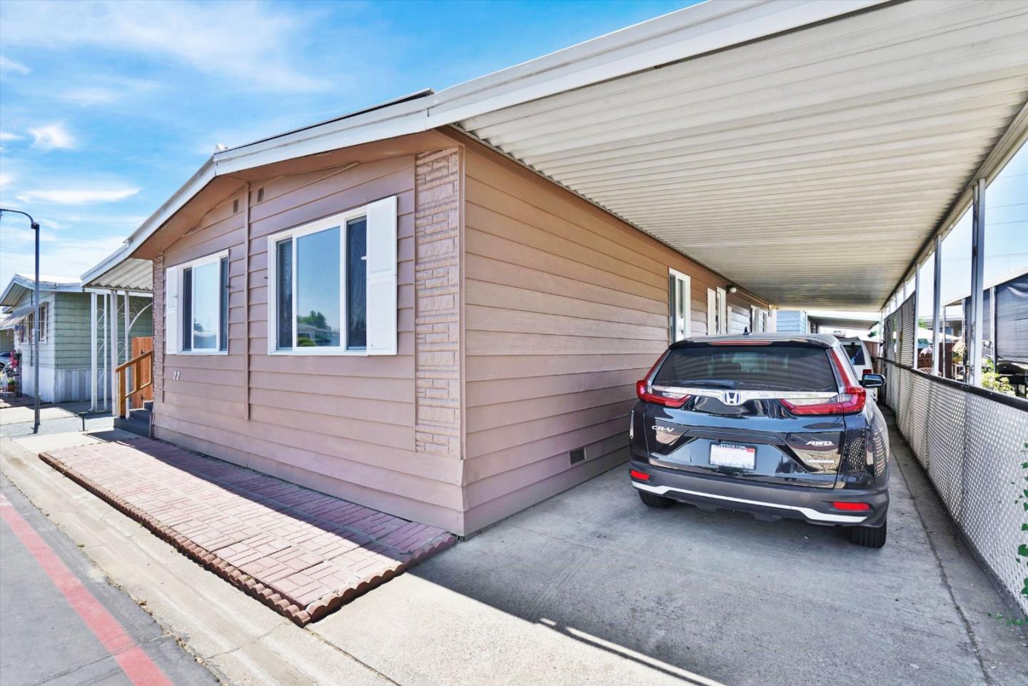 15820 South Harlan Road, Unit 22 Lathrop, CA 95330 - Photo 5 of 18 a front view of a house with parking