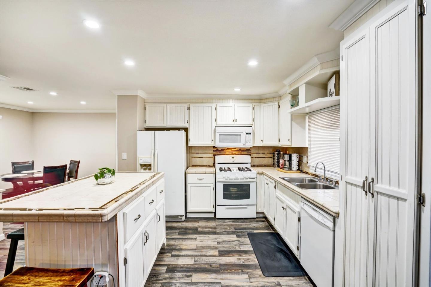 15820 South Harlan Road, Unit 22 Lathrop, CA 95330 - Photo 6 of 18 a kitchen with a sink stove and refrigerator