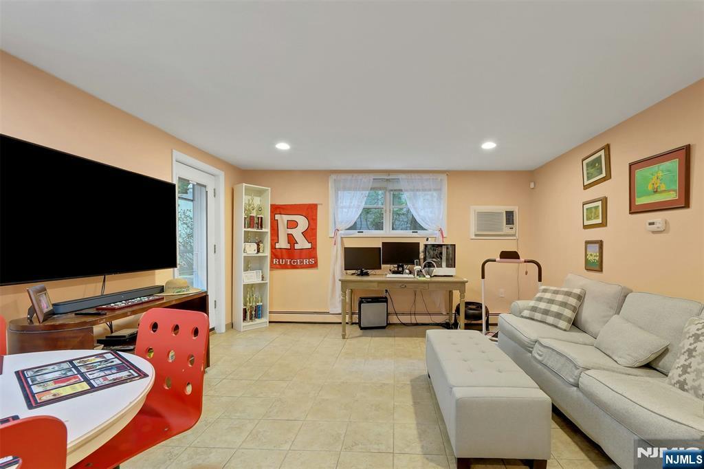 1093 Sheridan Street New Milford, NJ 07646 - Photo 18 of 45 a living room with furniture and a flat screen tv
