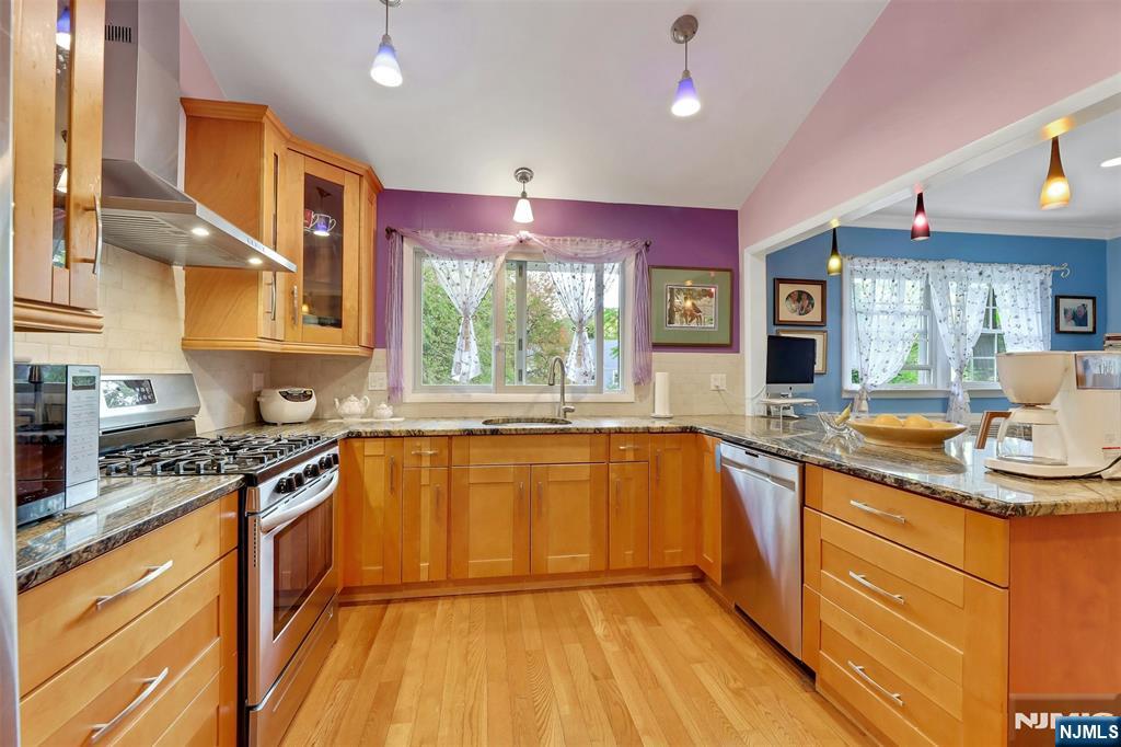 1093 Sheridan Street New Milford, NJ 07646 - Photo 33 of 45 a kitchen with stainless steel appliances granite countertop a sink stove and cabinets