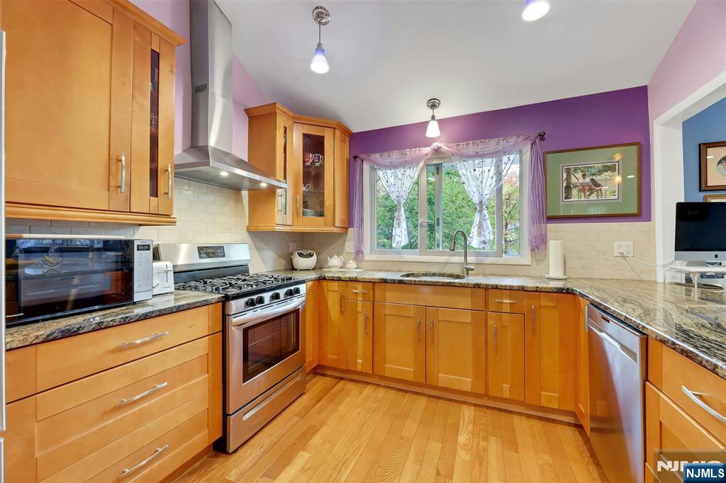 1093 Sheridan Street New Milford, NJ 07646 - Photo 35 of 45 a kitchen with stainless steel appliances granite countertop a stove a sink and a microwave