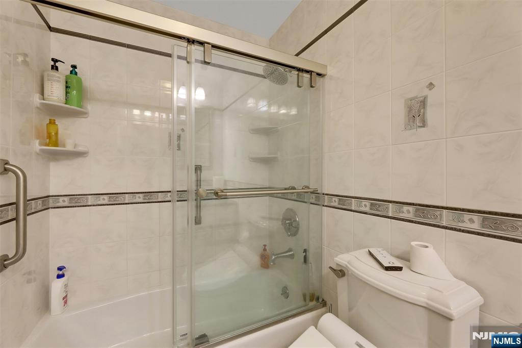 1093 Sheridan Street New Milford, NJ 07646 - Photo 37 of 45 a bathroom with a shower and a shower