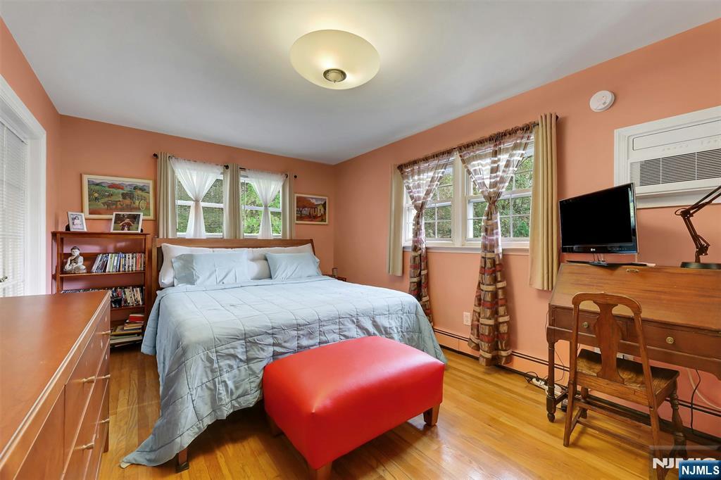 1093 Sheridan Street New Milford, NJ 07646 - Photo 38 of 45 a bedroom with a bed and wooden floor