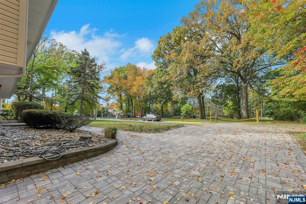 1093 Sheridan Street New Milford, NJ 07646 - Photo 7 of 45 a view of a yard with plants and trees