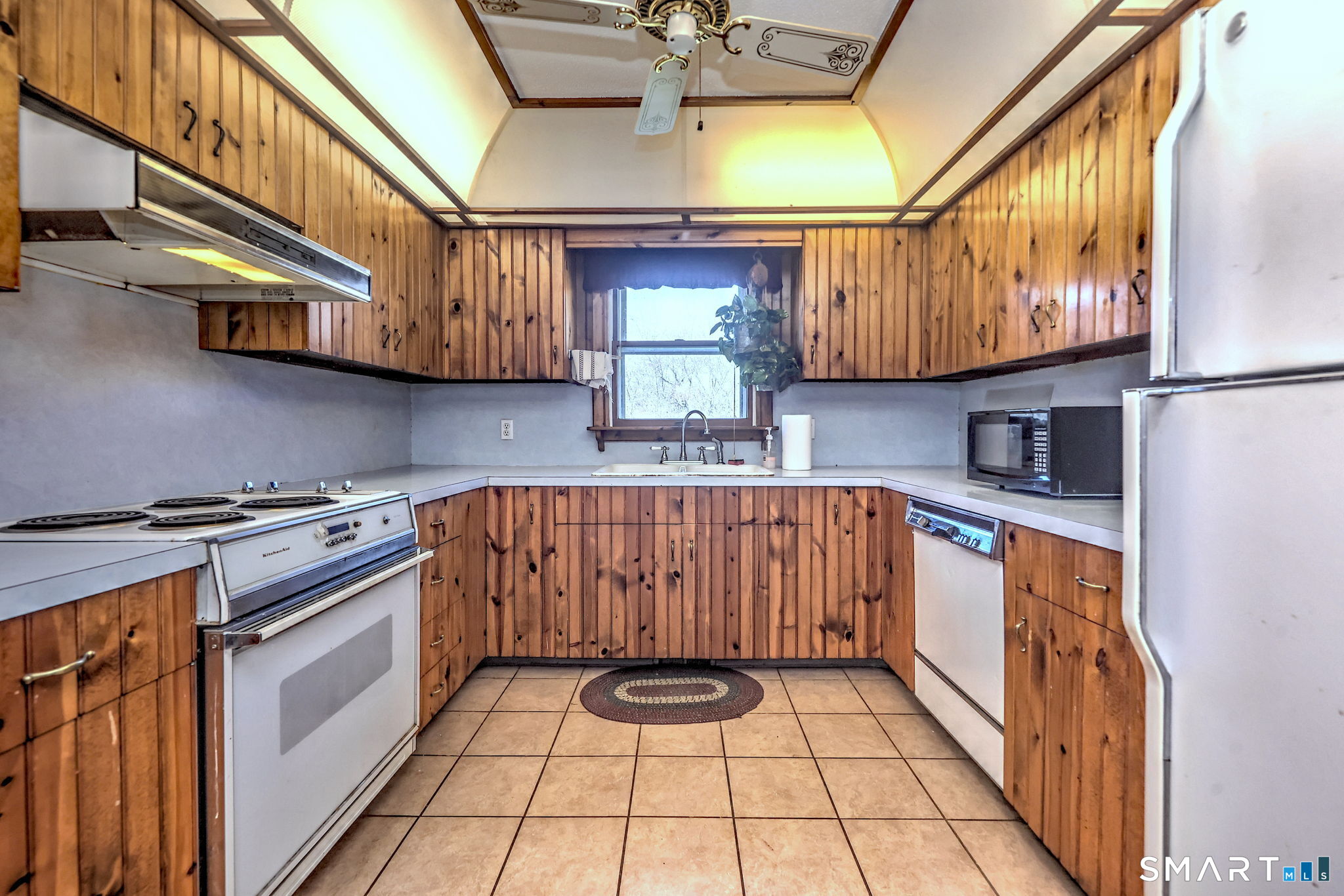 55 East Rutland Road Milford, CT 06461 - Photo 8 of 20 a kitchen with stainless steel appliances granite countertop a stove a sink and a microwave