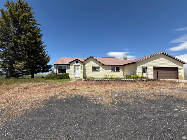 2002 Lund Road Bancroft, ID 83217 - Photo 1 of 28 Ranch-style residence featuring a metal roof and an attached garage with a brown door