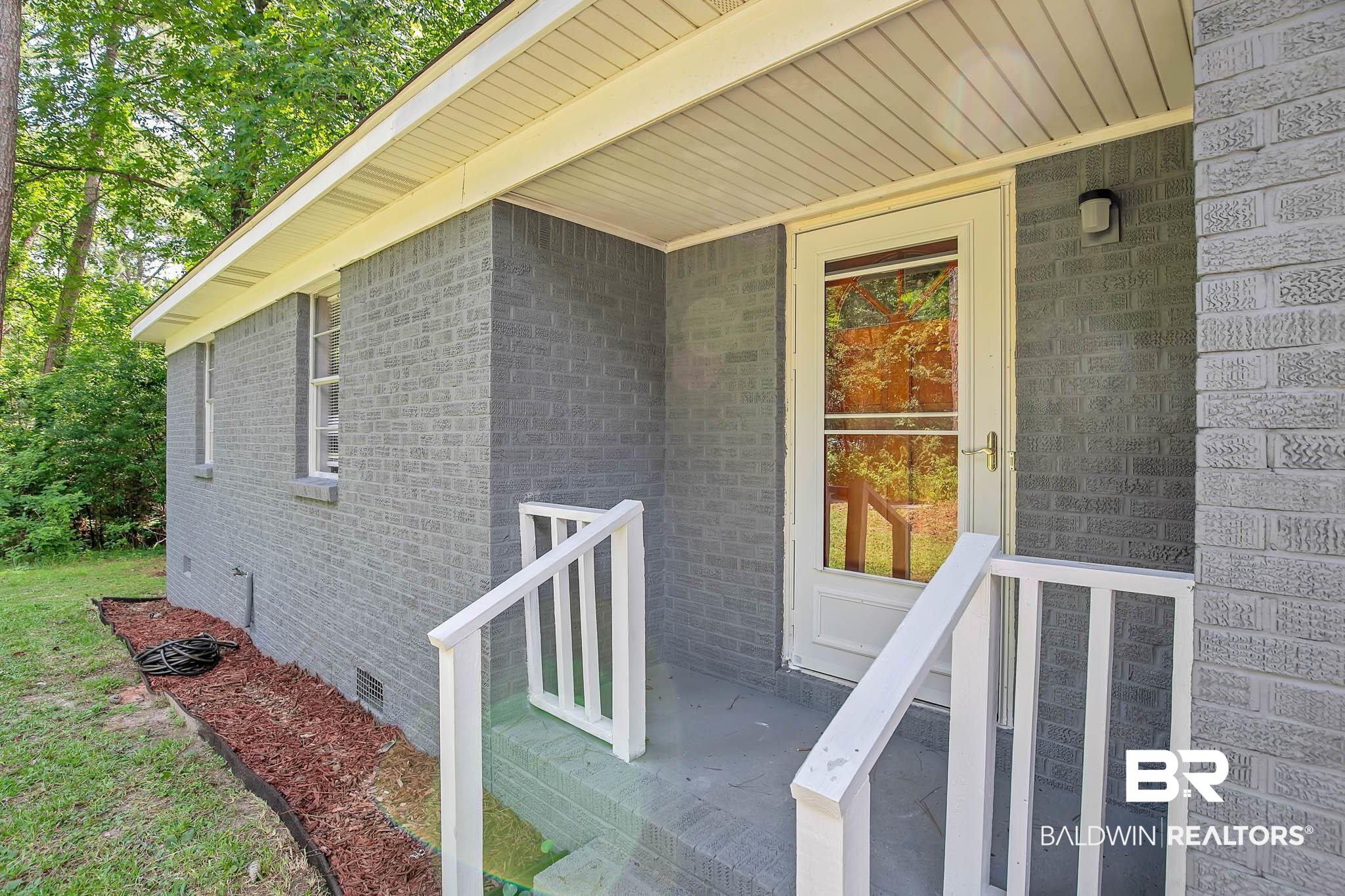 3304 Armond Drive Mobile, AL 36605 - Photo 42 of 62 Doorway to property with crawl space and brick siding