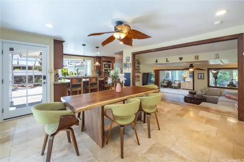 a dining room with furniture and a large window