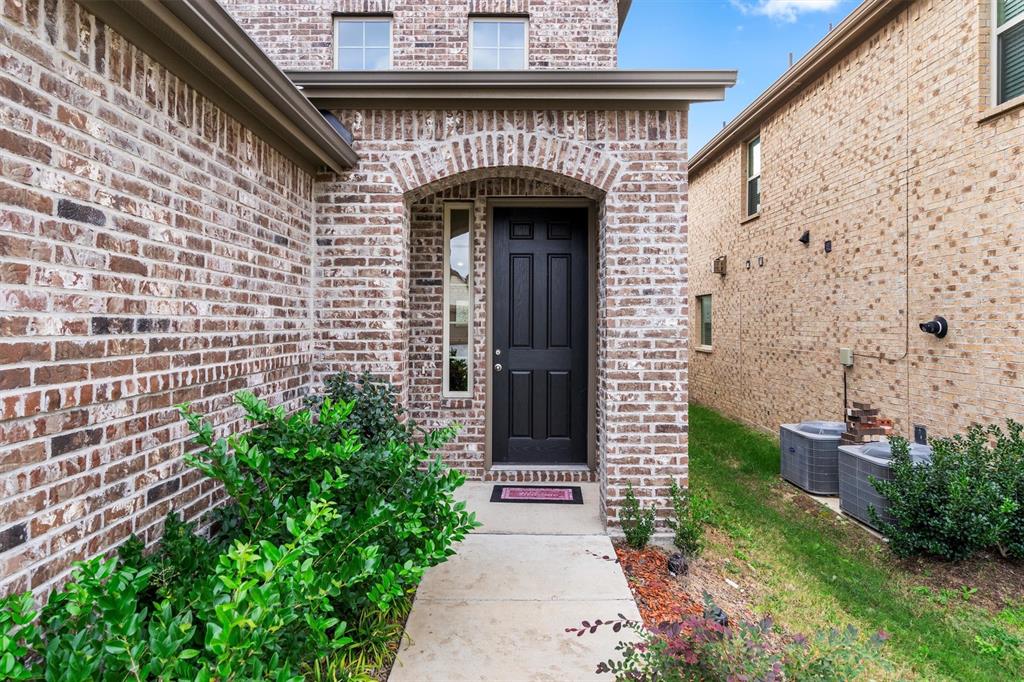2407 Neff Lane Forney, TX 75126 - Photo 2 of 22 a front view of a house with potted plants