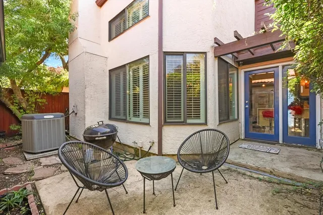 a view of a chairs and table in the patio