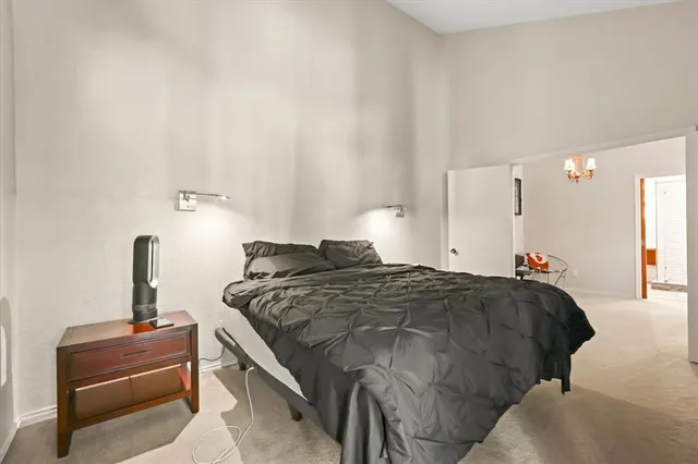 a bedroom with a bed and a lamp on table