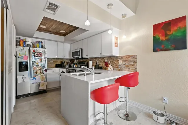 a kitchen that has a lot of cabinets and refrigerator