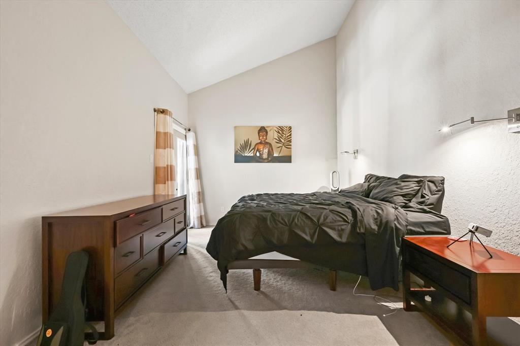 18040 Midway Road, Unit 225 Dallas, TX 75287 - Photo 14 of 24 a bedroom with a bed and wooden floor