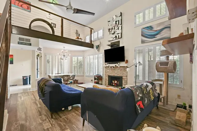 a living room with fireplace furniture and a flat screen tv