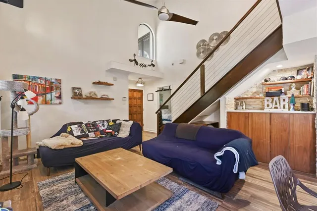 a living room with furniture rug and wooden floor