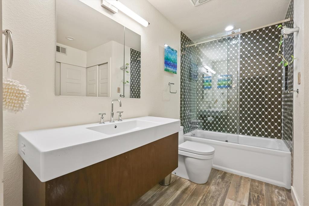 18040 Midway Road, Unit 225 Dallas, TX 75287 - Photo 10 of 24 a bathroom with a sink toilet and shower
