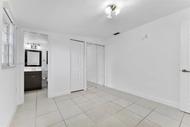a view of kitchen with windows cabinet and refrigerator
