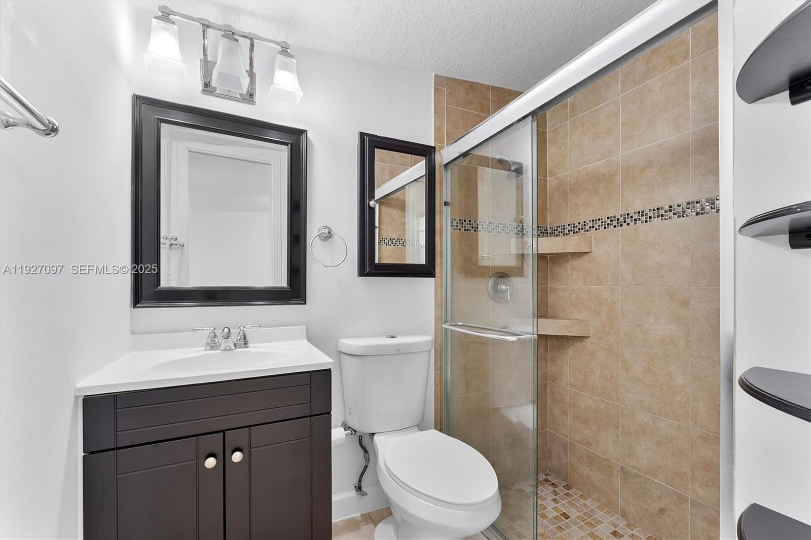 5511 Southwest 36th Court Davie, FL 33314 - Photo 14 of 23 a bathroom with a toilet a sink a mirror and a shower