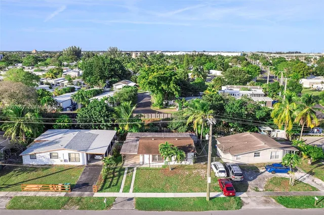 an aerial view of residential houses with outdoor space and street view