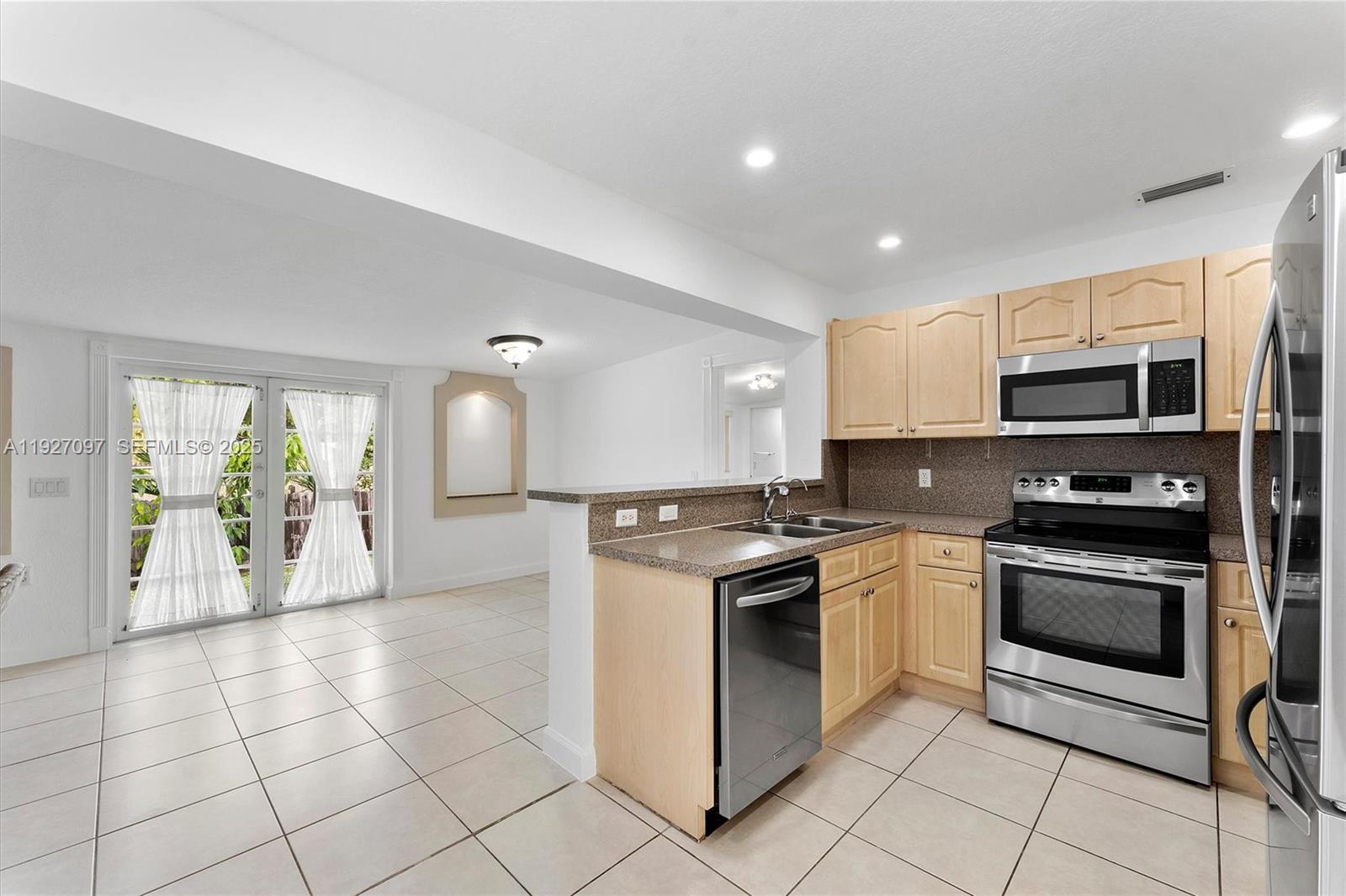 5511 Southwest 36th Court Davie, FL 33314 - Photo 8 of 23 a kitchen with stainless steel appliances granite countertop a stove a sink and a microwave