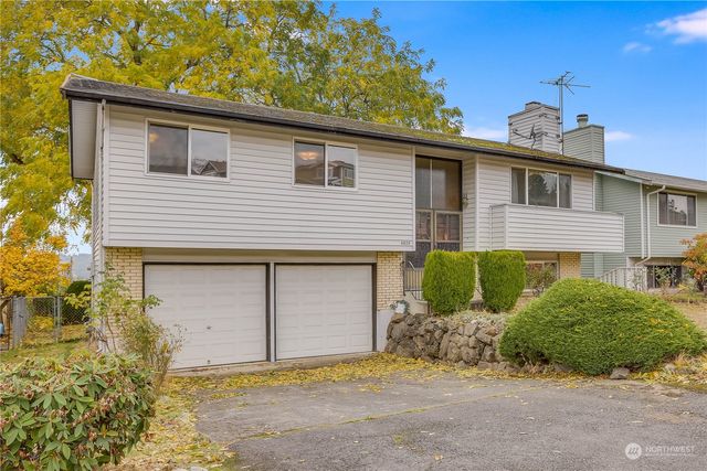 a front view of a house with a yard and garage