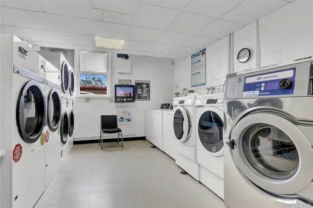 a view of a storage and utility room with washer and dryer