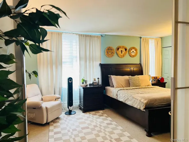 a bedroom with a bed and a couch