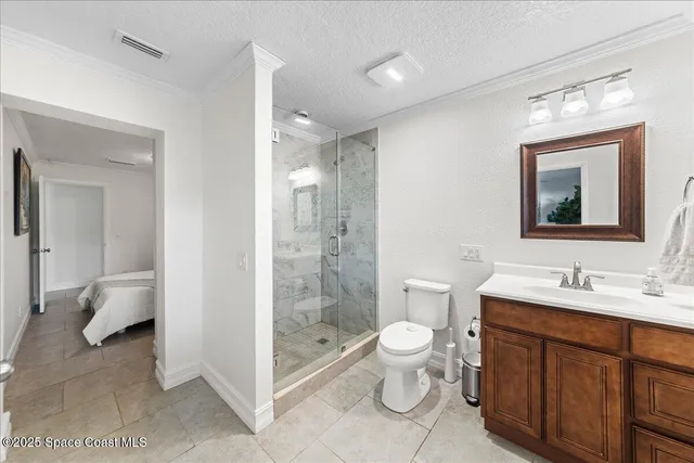 a bedroom with a bed and a lamp on the dresser