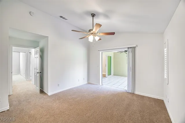 a view of an empty room with a ceiling fan