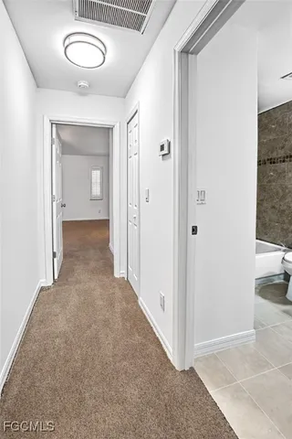 a view of a room with a barbeque and wooden stairs