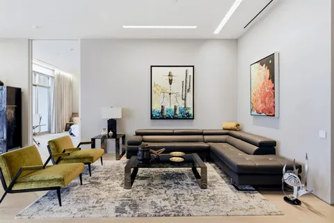 a living room with furniture and a piano