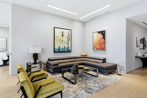 a living room with furniture and a piano
