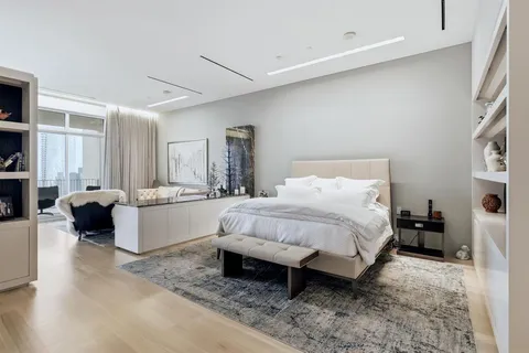 a spacious bedroom with a bed and a couch