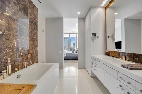 a en suite bathroom with a double vanity sink a mirror and a shower