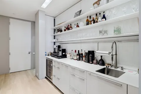 a kitchen with a sink dishwasher a stove and cabinets