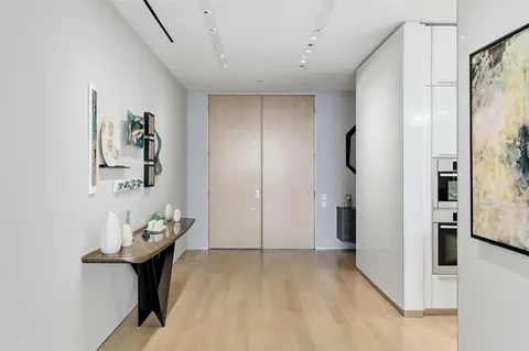 a view of a hallway with bathroom