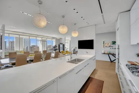 a large white kitchen with a large window